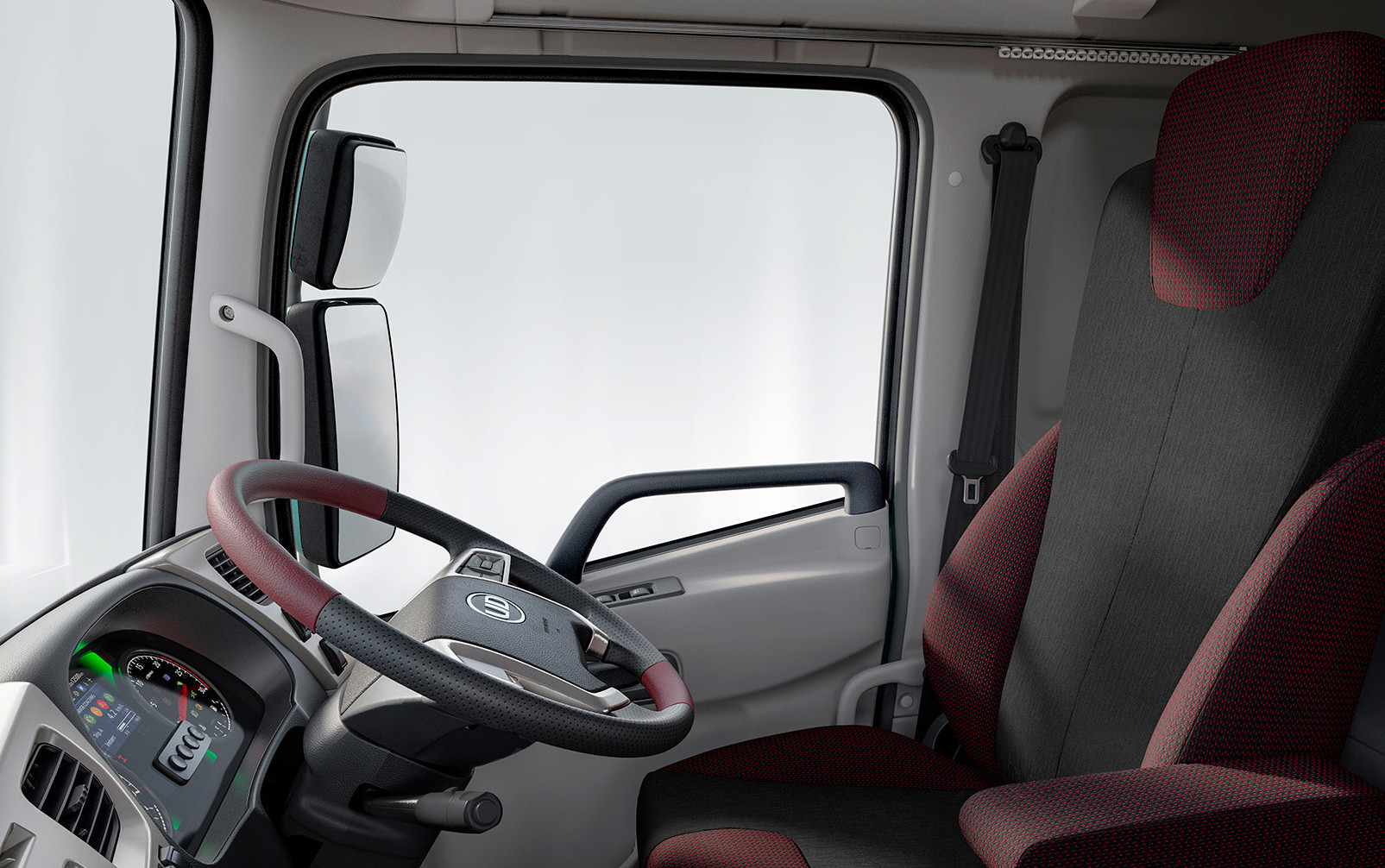 Truck cabin interior with a maroon and black driver's seat and modern dashboard.