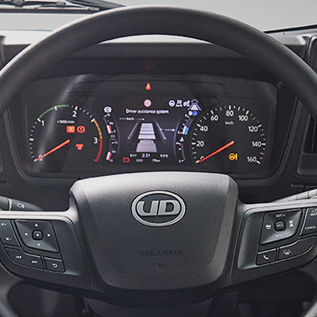 Truck steering wheel with UD logo and digital dashboard display.