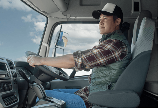 បុរសម្នាក់កំពុងបើករថយន្តធំ នៅក្នុងកាប៊ីន